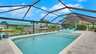 Pool und Whirlpool der Villa Kamala in Cape Coral mit überdachter Terrasse und Kanalblick. - Traum-Urlaub-Florida