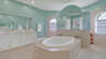 Luxuriöses Badezimmer mit ovaler Badewanne, Doppelwaschbecken und stilvollem Farbkonzept in Aquagrün. - Traum-Urlaub-Florida
