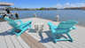 Zwei türkise Adirondack-Stühle mit Beistelltisch auf dem Sonnendeck mit Blick auf das Wasser. - Traum-Urlaub-Florida