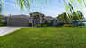 Villa Mei Jing in Cape Coral mit gepflegtem Vorgarten, Palmen und tropischem Flair  - Traum-Urlaub-Florida