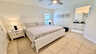 Ruhiges Schlafzimmer mit übergrossem Doppelbett, Nachttischen, Deckenventilator und direktem Zugang zum modernen Bad. - Traum-Urlaub-Florida